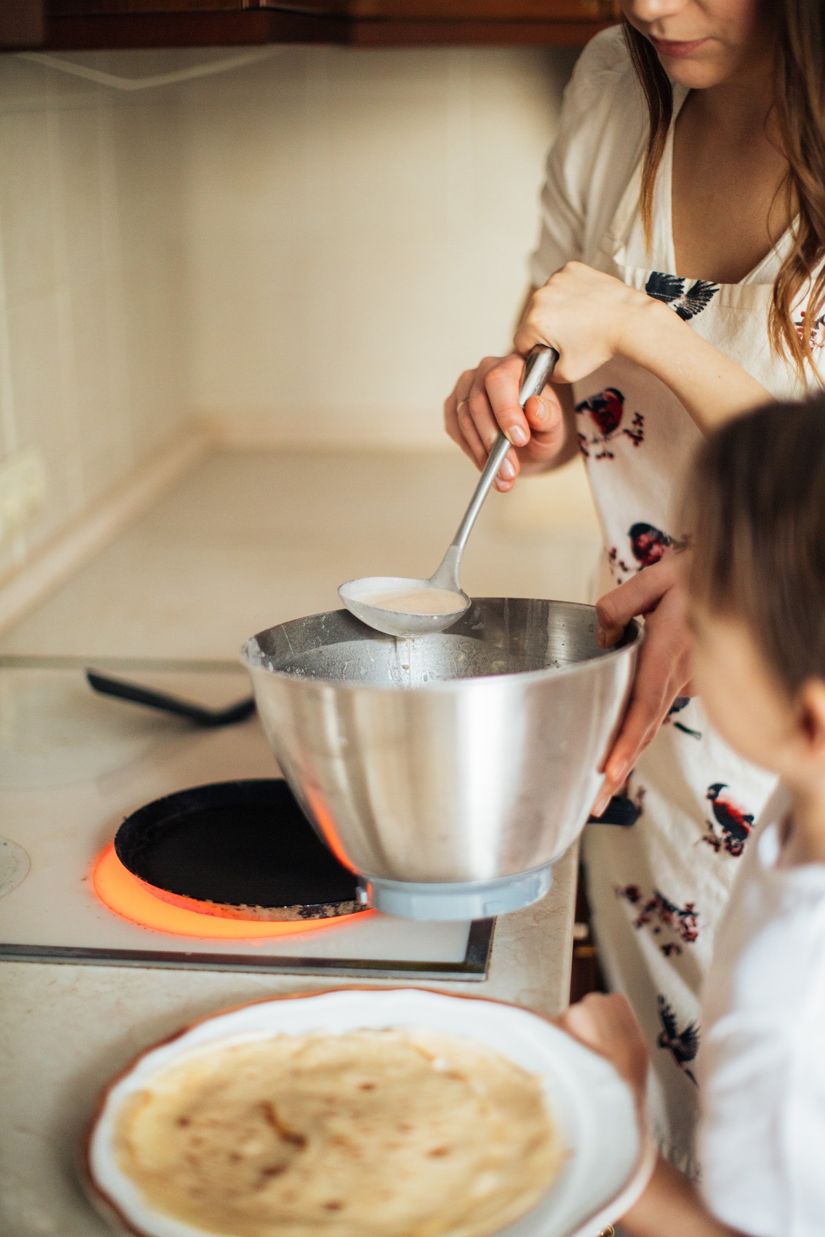 woman-in-white-shirt-holding-ladle-and-stainless-steel-bowl-3807336